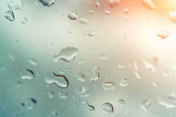 Water drops on glass against blue sky. Window view background screensaver. Place for text banner.