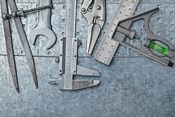 Construction Tools Composed On Metallic Background.