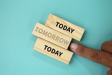 wooden arrangement with the word TOMORROW rejected. the concept of today and tomorrow with today's...