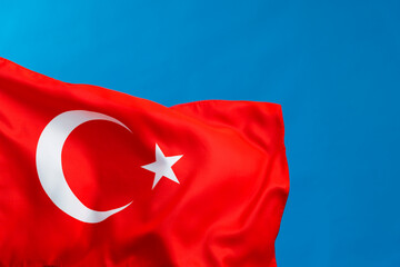 Turkish flag waving on blue background