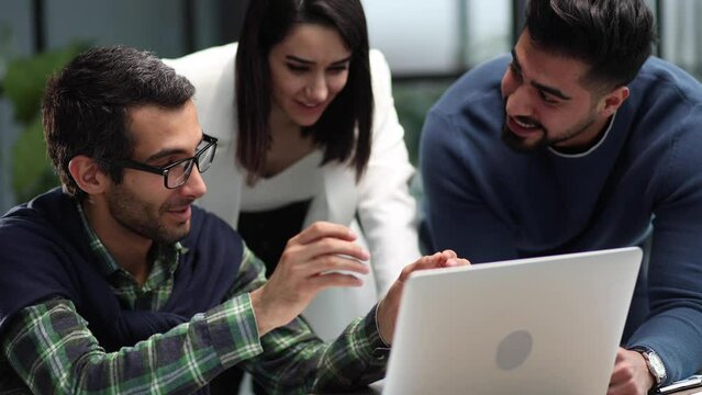 Business partners discuss financial reports, plan an investment strategy. Team of three