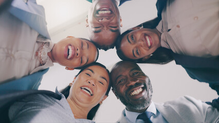 Business people, face and low angle in circle for team building, meeting or motivation together at office. Group of employees or colleagues smile in diversity for teamwork, unity or community below