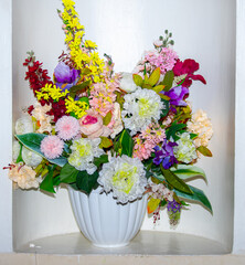 Large bouquet of flowers closeup in a white vase