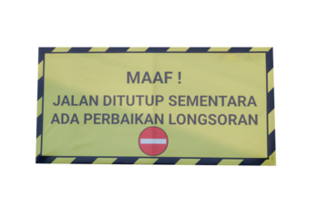 yellow warning board with the words "MAAF ! JALAN DITUTUP SEMENTARA ADA PERBAIKAN LONGSORAN" in English means SORRY! THE ROAD IS CLOSED WHILE THERE IS AVALANCHE REPAIR