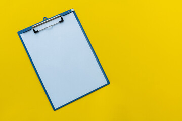 Clipboard with a paper on yellow background