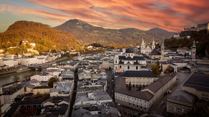 Poster Autumn season at a historic city of Salzburg with Salzach river in beautiful sunset sky and colorful of autumn scene Salzburger Land, Austria © SASITHORN