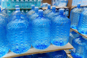 Bottles with clean water in a hyper package. Sale of drinking water. Selective focus