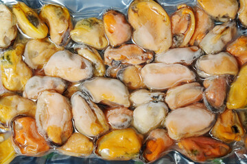 Frozen mussels background. Frozen seafood. Wholesale of fish. Peeled mussels