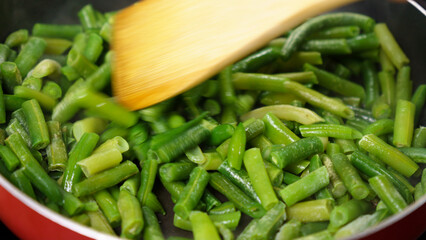 Green Beans Sizzling in Pan, Creating a Mouthwatering Dish. Selective focus