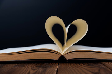 Book pages curved into heart shape