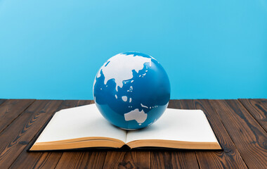 Earth globe on open book