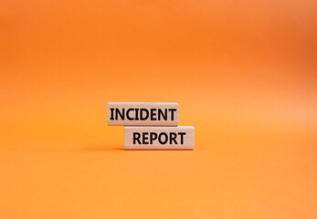 Incident Report symbol. Concept word Incident Report on wooden blocks. Beautiful orange background....