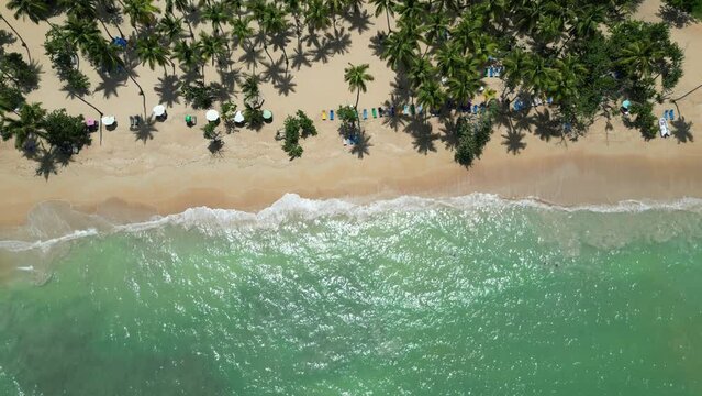 Aerial view of tourists bathing in the turquoise waters at Punta Popy beach in the tourist town of Las Terrenas in the Dominican Republic