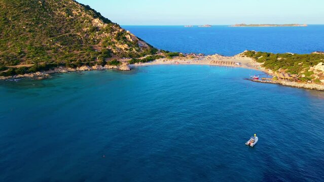 flying over turquoise water of Punta Molentis Beach, Villasimius, Sardinia, Italy