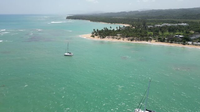 Luxurious catamarans in the turquoise waters at Punta Popy beach in Las Terrenas on the caribbean island of Dominican Republic