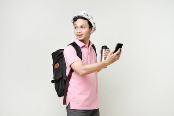 Asian man backpacker hold mobile phone and tumbler bottle. travelling concept. on isolated background