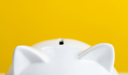 Piggy bank on yellow background