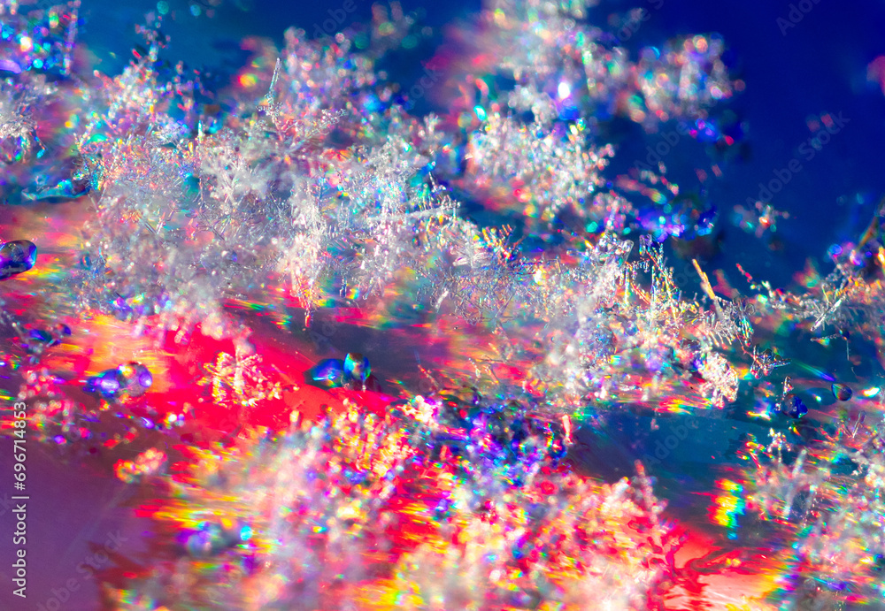 Sticker Close-up of snowflakes on a red-blue background. Macro