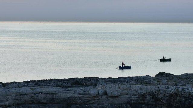 Aerial footage off the coast of Monopoli revealing to fishermen on their boats on the Mediterranean.