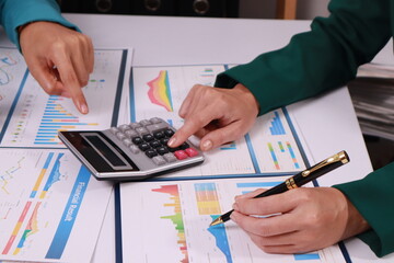 Business Woman accounting discussing financial with calculator and business chart and graph