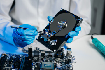 Obraz premium The technician is putting the CPU on the socket of the computer motherboard. electronic engineering electronic repair, electronics