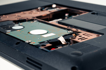Close-up of a broken hard disk drive on a white background