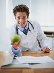 Happy, apple and portrait of man doctor with stethoscope for positive, good and confident attitude. Smile, pride and young male healthcare worker with fruit in medical office of hospital or clinic.