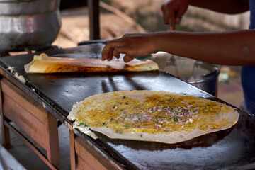 Dosa making at the road side veg restaurant or stall.