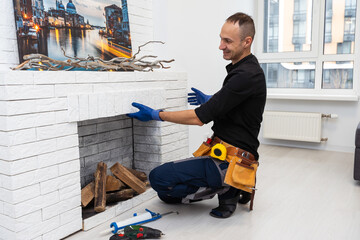Fireplace installing in white brick wall.