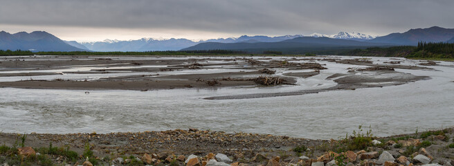 landscape with mountains and a braided muddy glacial river, Yukon Territory, Canada
