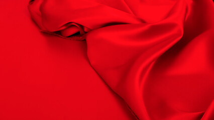 Colorful luxury red silk satin background. Beautiful soft folds. Shiny fabric. Space for design. Christmas, Birthday, Valentine day, Valentine, Mother's day, festive. Banner.