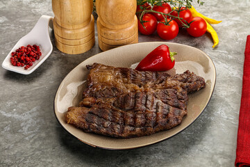 Grilled chuck roll steak with arugula