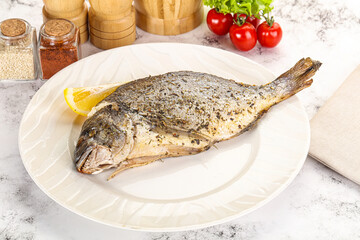 Baked Dorado fish served lemon