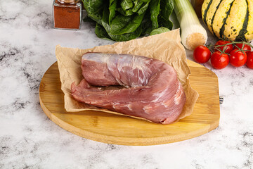Uncooked raw pork tenderloin with spices