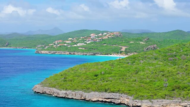 Aerial pan reveals Cas Abou beach, Christoffelberg, and beautiful blue sea water