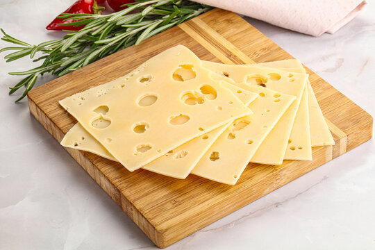 Sliced maasdam cheese with holes