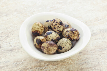 Raw quail eggs heap in the bowl