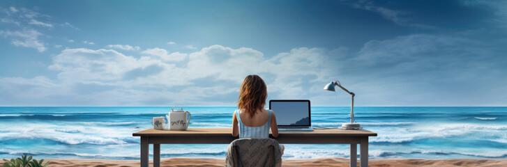 Rear view of young woman, female freelancer in straw hat working on laptop, while sitting on the tropical sandy beach.