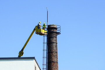 Inspection of the technical condition of an old tall brick chimney using a telescopic boom platform