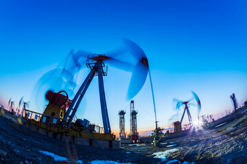 In the evening, oil pumps are running, Silhouette of beam pumping unit