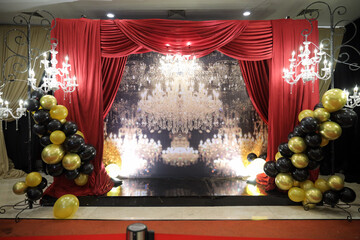 A colorful venue stage set decoration with lighting and led big screen for sweet17th birthday party...