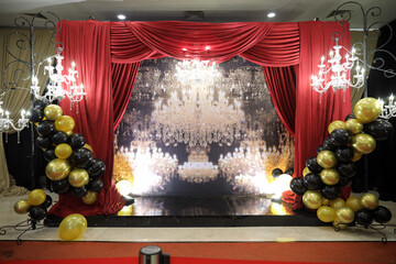 A colorful venue stage set decoration with lighting and led big screen for sweet17th birthday party or any event. Indoors wedding ceremony decorations.