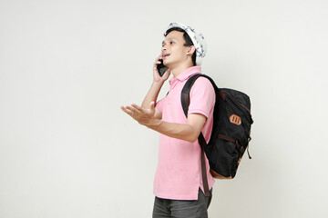 Asian man backpacker making a phone call. digital nomad and travelling concept. on isolated...