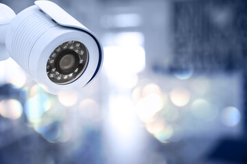 Modern security CCTV camera against blurred background, space for text