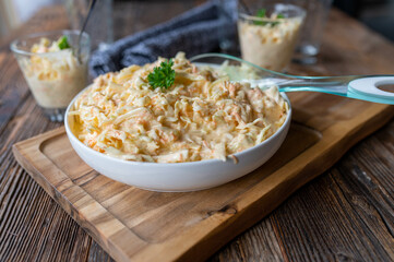 Coleslaw traditional american Party salad served ready to eat on a rustic and wooden table background for Party food