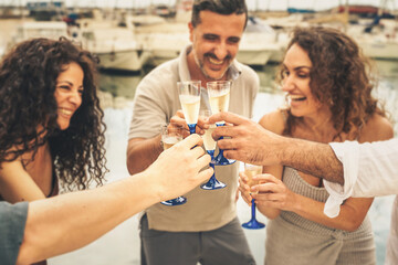 Joyful Friends Toasting with Champagne at marina