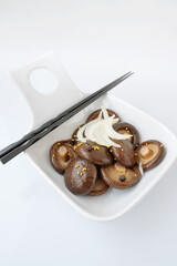 marinated shiitake. canned shiitake on a plate close-up. Top view, copy space
