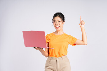 Portrait of cheerful happy Asian woman posing on white background