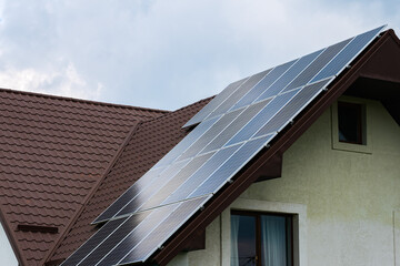 Solar panels installed on the metal roof of the house