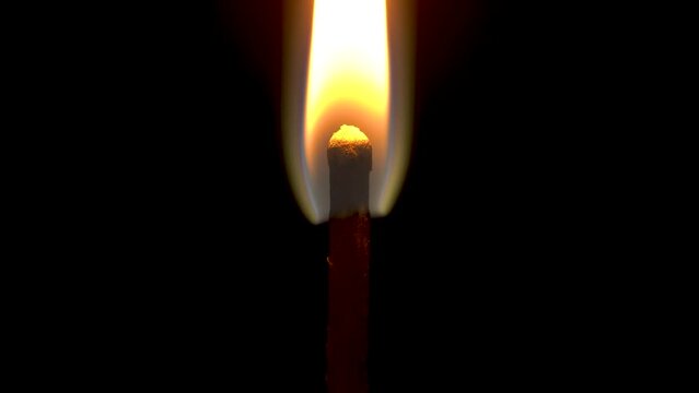 The match is burning on a black background